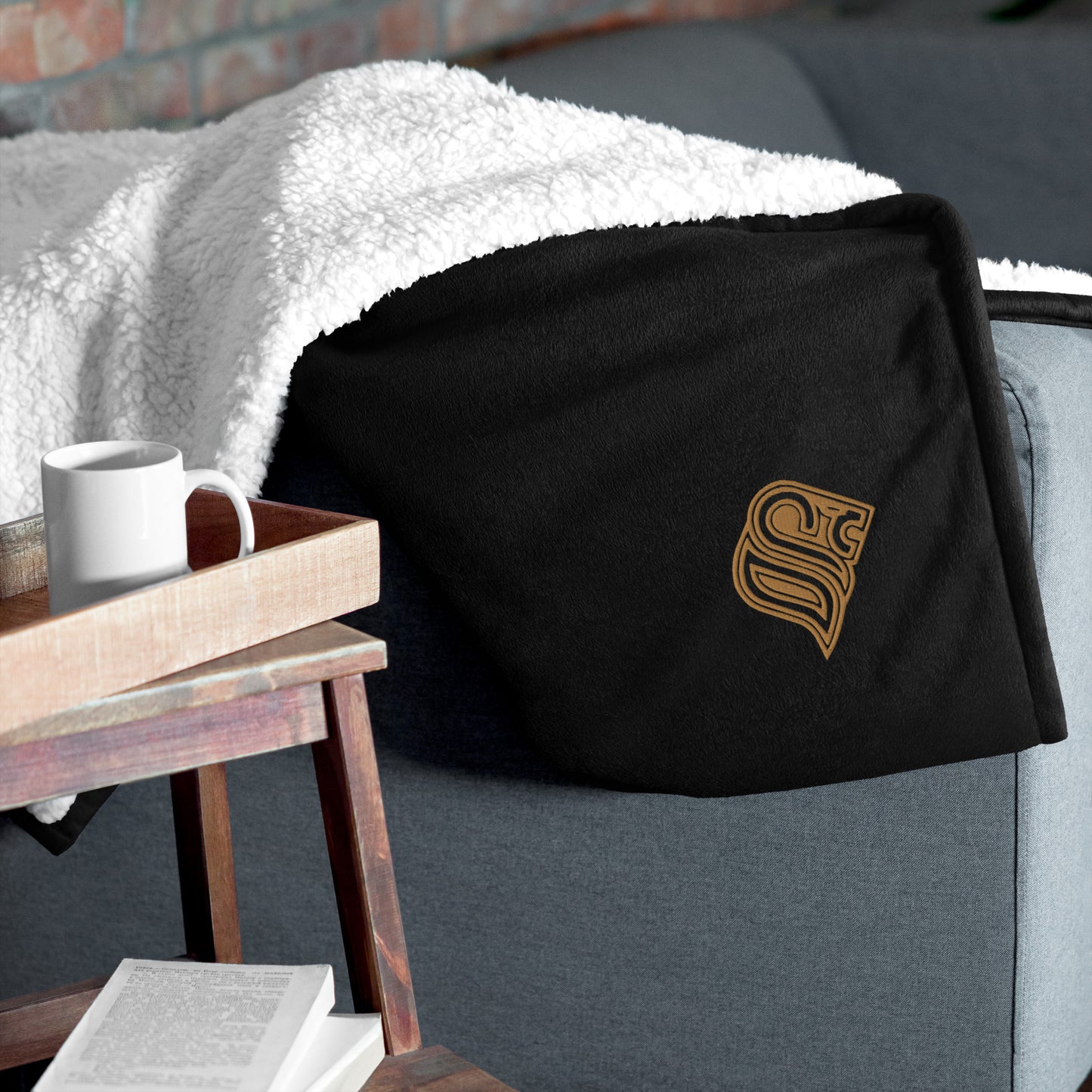 Embroidered logo sherpa blanket